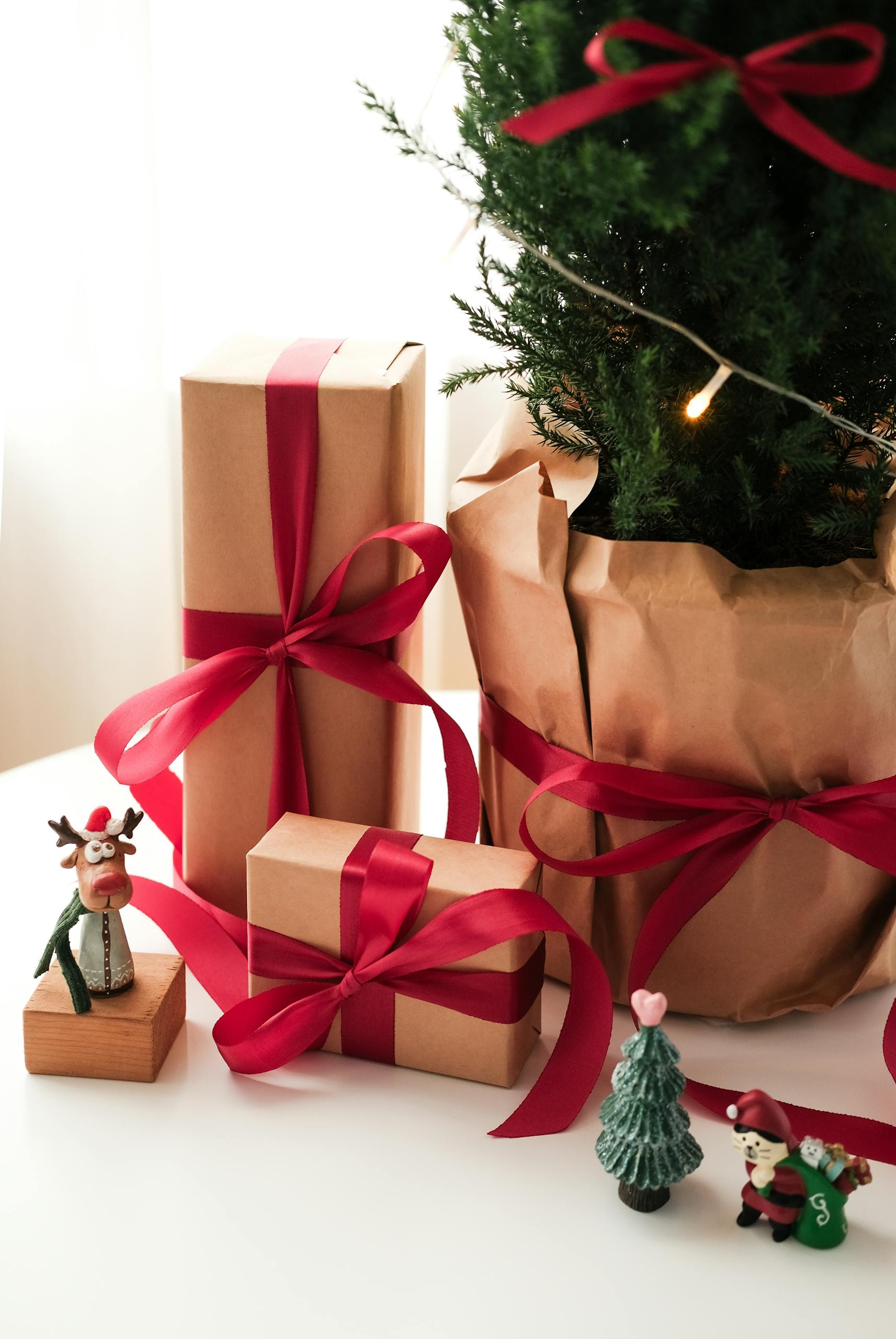 Festive Christmas gifts and tree with decorations, invoking holiday cheer.